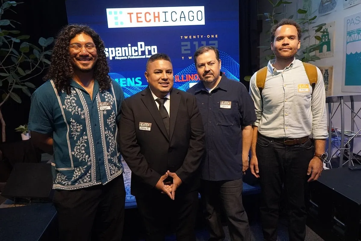 Four men standing together in front of the TechChicago and HispanicPro stage backdrop