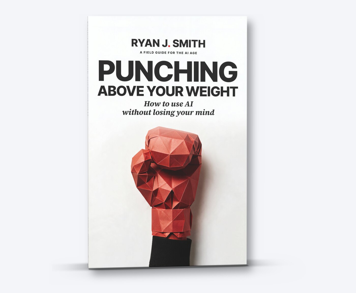 The Punching Above Your Weight paperback standing on a pale grey ground, a red paper boxing glove raised on its cover