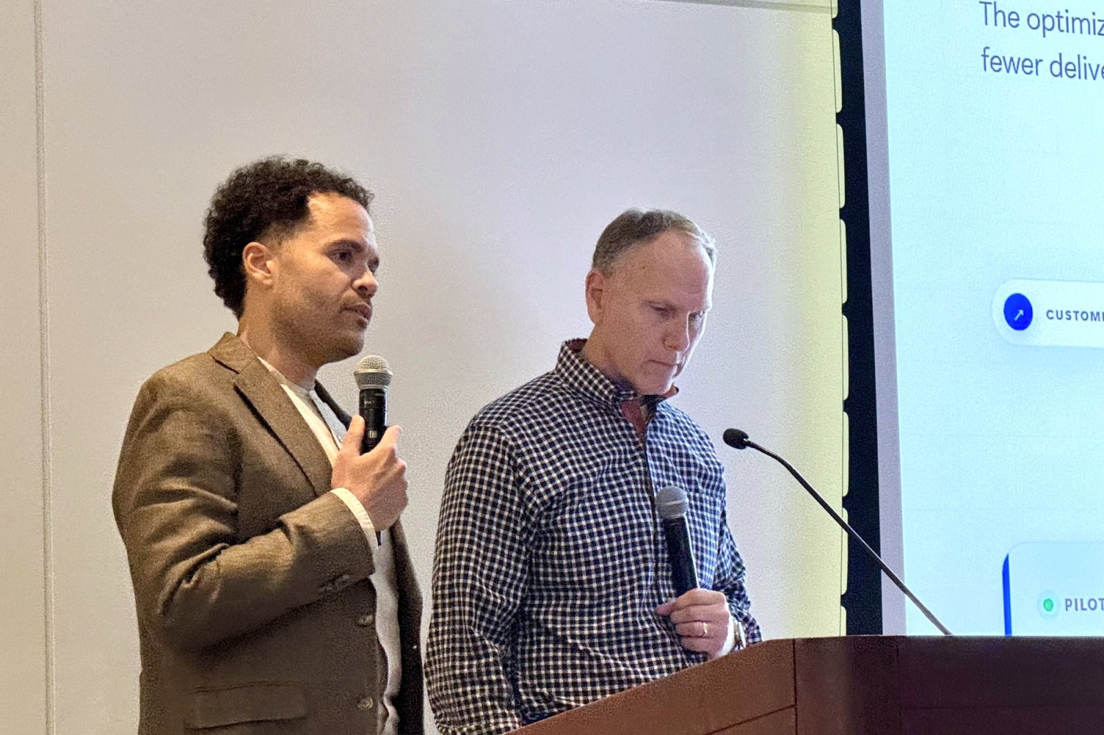 Ryan presenting a supply chain AI product with a colleague at a corporate AI summit